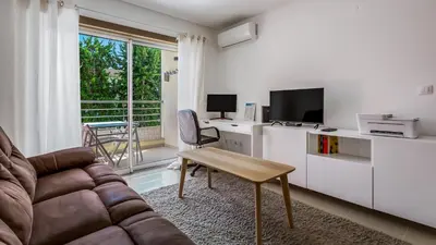 a living room with a couch and a table at Luminous 2 BDR Apartment W/Pool by LovelyStay in Albufeira