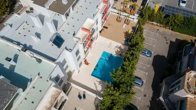 an overhead view of a city with a swimming pool at Luminous 2 BDR Apartment W/Pool by LovelyStay in Albufeira