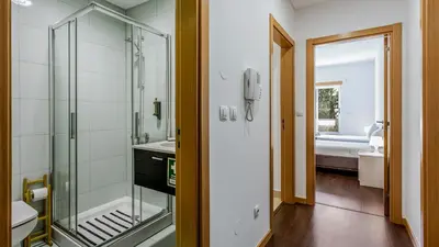 a bathroom with a glass shower and a sink at Luminous 2 BDR Apartment W/Pool by LovelyStay in Albufeira