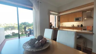 a kitchen with a table with a bowl of fruit on it at Albufeira Oasis Retreat in Albufeira