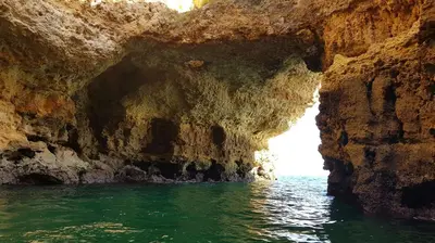 a cave in the water next to the ocean at Albufeira Oasis Retreat in Albufeira