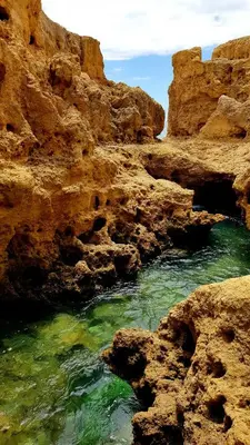 a body of water in a canyon with rocks at Albufeira Oasis Retreat in Albufeira