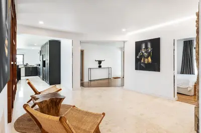a living room with a chair and a painting on the wall at Casa Chameleon in Almancil