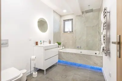 a white bathroom with a tub and a sink at Casa Chameleon in Almancil