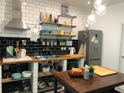 a kitchen with a counter and a refrigerator at Orange Terrace Hostel in Albufeira