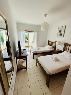 a living room with two beds and a table at Ferreiras Villa in Albufeira