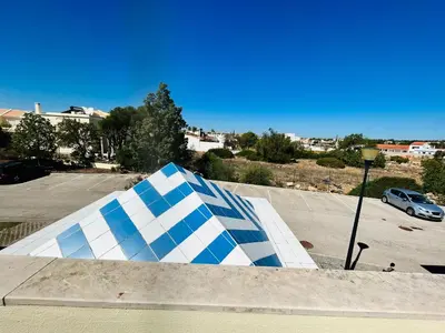 a blue and white skateboard ramp in a parking lot at Ferreiras Villa in Albufeira