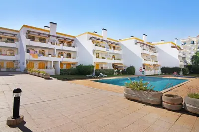 a large apartment building with a swimming pool at Vila Mar Azul in Quarteira