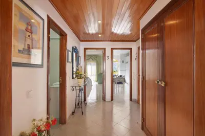 a hallway of a home with wooden ceilings and doors at Vila Mar Azul in Quarteira