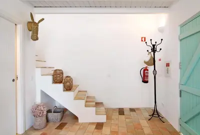a white staircase in a room with a blue door at Casa de Benafim 51 in Benafim
