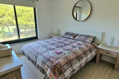 a bedroom with a bed and a mirror on the wall at Spacious Residence Golf apartment - Vilamoura in Quarteira