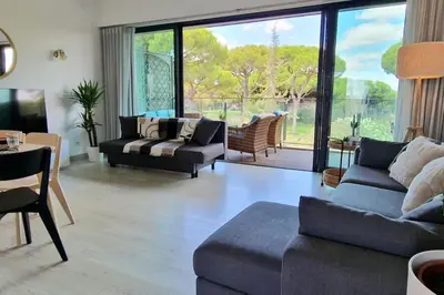 a living room with two couches and a table at Spacious Residence Golf apartment - Vilamoura in Quarteira