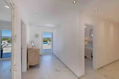 a white hallway with a desk and a bedroom at Casa Emella Luxury Villa Albufeira in Albufeira