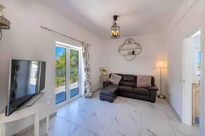 a living room with a couch and a tv at Casa Emella Luxury Villa Albufeira in Albufeira