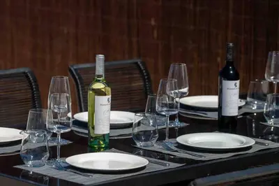 a table with two bottles of wine and glasses at Casa Emella Luxury Villa Albufeira in Albufeira