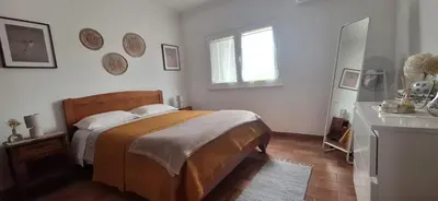 a bed with a keyboard and a cup on a table at Solar da Cotovia in Albufeira