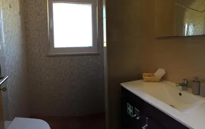 a kitchen with a table and a chair in a room at Solar da Cotovia in Albufeira