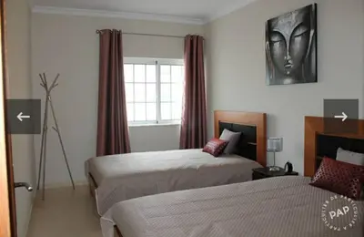 a hotel room with two beds and a window at Casa Mar à Vista in Cavacos