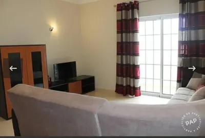 a living room with a couch and a television at Casa Mar à Vista in Cavacos