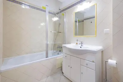 a bathroom with a sink and a tub and a shower at Sea-Front 1' Min! - Apartment with AC & WiFi in Quarteira