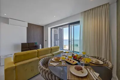 a living room with a couch and a table at Terracos de Quarteira II Yellow by Real Properties in Quarteira