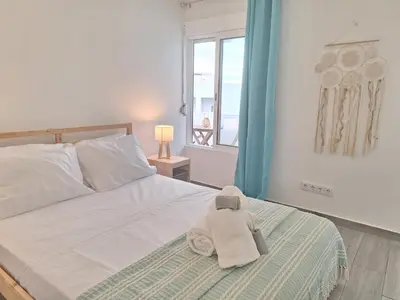 a stuffed animal sitting on a bed in a bedroom at Cool living Quarteira, 2 bedroom with ocean view in Quarteira