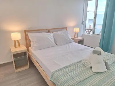 a bedroom with a bed with a stuffed animal on it at Cool living Quarteira, 2 bedroom with ocean view in Quarteira