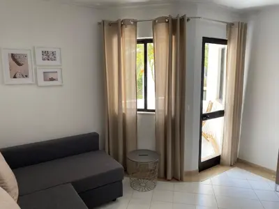 a living room with a couch and a window at Casa Porto Marina in Vilamoura