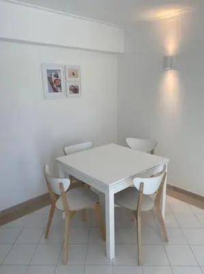 a white table and chairs in a room at Casa Porto Marina in Vilamoura