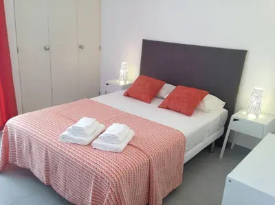 a bedroom with a bed with two towels on it at Casa Vila Magna T1 in Albufeira