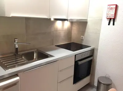 a small kitchen with a sink and a stove at Casa Vila Magna T1 in Albufeira