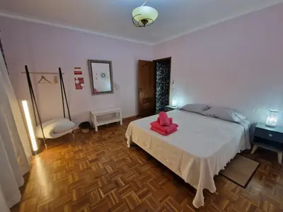 a bedroom with a bed with a red bow on it at Sleep and Fly in Faro