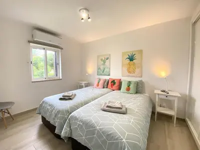 a bedroom with a large bed and a window at Albufeira Balaia Golf Vilage 3 With Pool by Homing in Albufeira