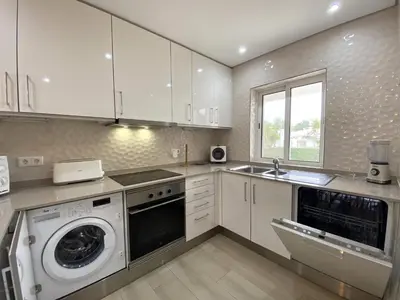 a kitchen with a washing machine and a sink at Albufeira Balaia Golf Vilage 3 With Pool by Homing in Albufeira