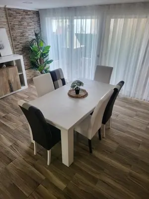 a dining room table and chairs in a room at Flor do Campo in Albufeira