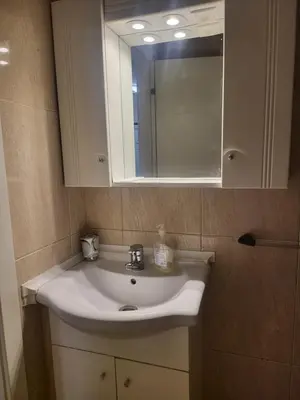 a bathroom with a white sink and a mirror at Flor do Campo in Albufeira