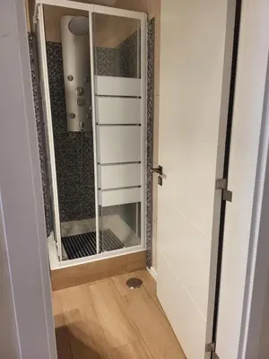 a bathroom with a mirror next to a shower at Flor do Campo in Albufeira