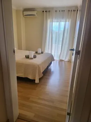 a bedroom with a bed and a large window at Flor do Campo in Albufeira