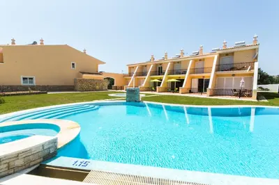 a large swimming pool in front of a building at Villa Durban in Albufeira