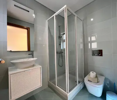 a bathroom with a shower and a sink and a toilet at Villa Durban in Albufeira