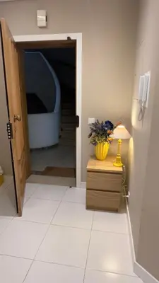 a hallway with a table with a vase on it at Tivoli AP Casino Vilamoura in Vilamoura
