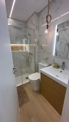 a bathroom with a shower and a toilet and a sink at Tivoli AP Casino Vilamoura in Vilamoura