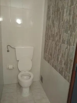 a bathroom with a white toilet in a room at Melaya Private Rooms in Faro