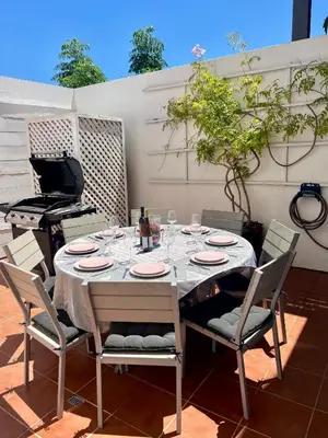 a table with plates and wine glasses and a piano at Vale do Lobo Algarve,Exclusive Private Pool Villa in Vale do Lobo