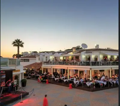 a group of people sitting on the balcony of a hotel at Vale do Lobo Algarve,Exclusive Private Pool Villa in Vale do Lobo