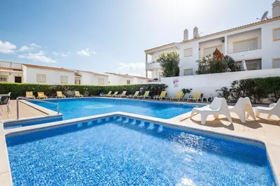 a swimming pool in the middle of a building at Sweet Home Arrifes in Albufeira