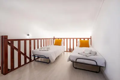 a room with two beds on a balcony at Sweet Home Arrifes in Albufeira