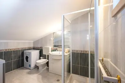 a bathroom with a toilet and a sink and a shower at Sweet Home Arrifes in Albufeira