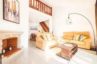 a living room with a couch and a fireplace at Sweet Home Arrifes in Albufeira