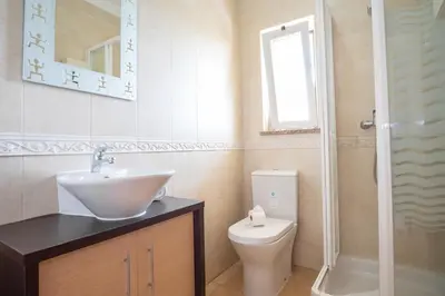 a bathroom with a sink and a toilet at Thiago Holidays Apartment in Albufeira